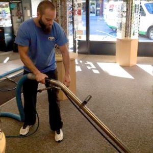 Photo of a man doing commercial carpet cleaning